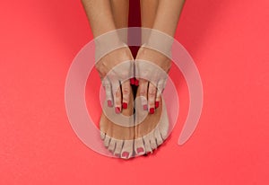 Beautiful female feet and hands at spa salon on pedicure and manicure procedure