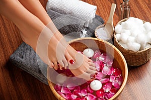 Beautiful female feet at spa salon on pedicure procedure.