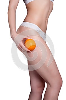 Beautiful female figure with an orange holds near the