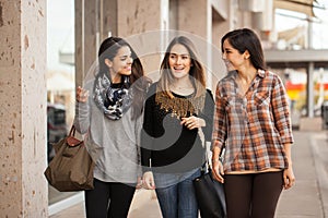 Beautiful female friends walking around a mall