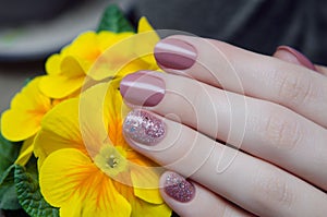 Beautiful female hand with beige nail design