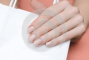 Beautiful female hand with beige nail design