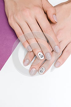 Beautiful female hand with dandelion nail design.