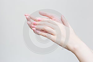 Beautiful female hand, female hand applying lotion or hand cream to hand care in spa and manicure concept