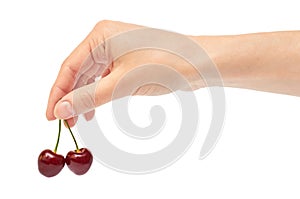 Beautiful female hand holds cherry gesture. Isolated on white background