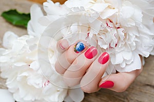 Beautiful female hand with red nail design