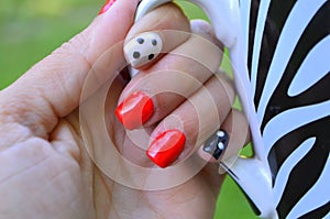 Beautiful female hand with red nail design