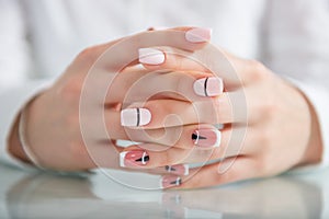 Beautiful female hands with a fashionable manicure. Geometric design of nails