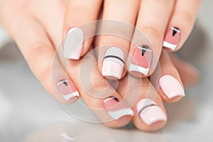 Beautiful female hands with a fashionable manicure. Geometric design of nails