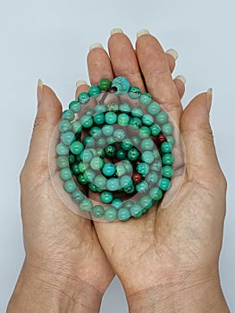 Beautiful female  hands holding turquoise mala beads