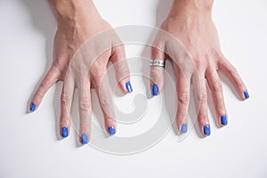 Beautiful female hands with manicure and blue nails