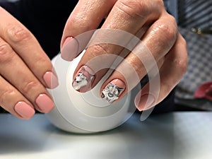 beautiful female hands with peach manicure and fashionable design