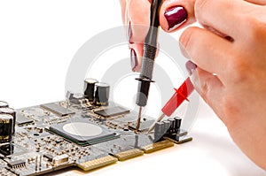 Beautiful female hands test the computer board