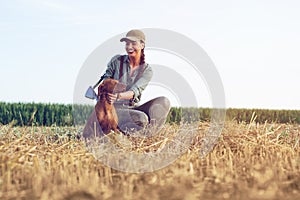 Beautiful female hunter with furry companion.