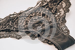 Beautiful female lacy black panties isolated on white background