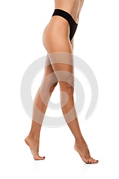Beautiful female legs isolated on white background. Beauty, cosmetics, spa, depilation, treatment and fitness concept
