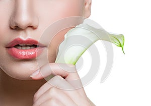 Beautiful female lips with natural color lipgloss and white lily calla flower isolated