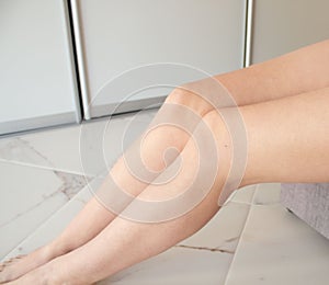 Beautiful female long legs with smooth skin after depilation. A young girl epilated her legs, her skin is silky. Body hair