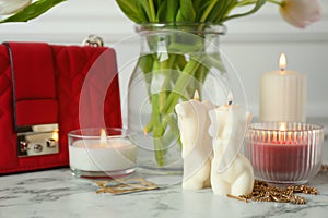 Beautiful female and male body shaped candles on white marble table. Stylish decor