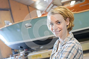 Beautiful female marine builder in shed