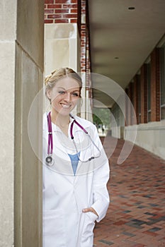 Beautiful female medical student wearing whitecoat