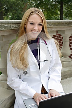 Beautiful female medical student wearing whitecoat