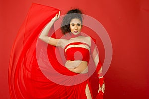 Beautiful female model in a flowy red dress