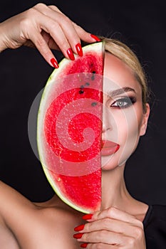 Beautiful female model with perfect face and smooth skin care, holding and eating watermelon fruit