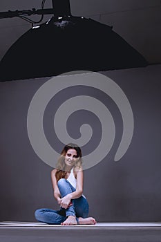 Beautiful female model posing at studio in the light softbox