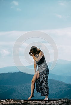 Beautiful female modern jazz contemporary style dancer on a mountain