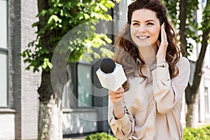 beautiful female news reporter taking interview photo