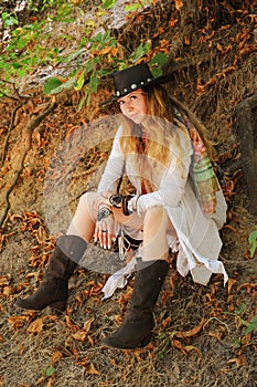 Beautiful female portrait dressed in dreamcatcher bracelets and black leather hat, indie style