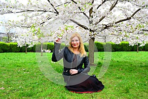 Beautiful female posing in the sakura garden