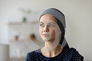 Beautiful female recovering from oncology wearing elegant scarf on head