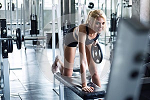 A beautiful female smile and training with dumbbell