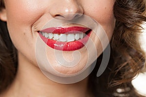Beautiful female smile with white teeth and red lips closeup beauty portrait