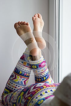 and beautiful female soles and feet crossed on windowsill photo