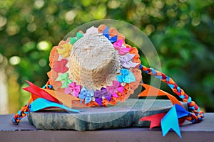 Beautiful female straw hat filled with small colored ribbons and orange lace and ribbon braid