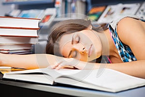 Beautiful female student in a library