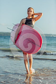 beautiful female surfer with surfboard