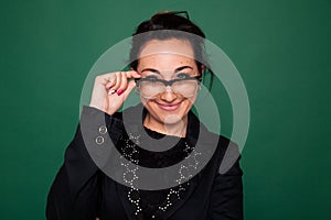 Beautiful female teacher at the classroom board at school