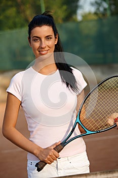 Beautiful female tennis player smiling