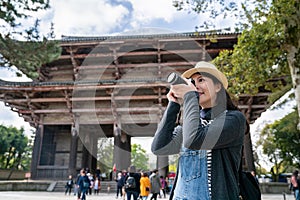 A beautiful female tourist taking photo