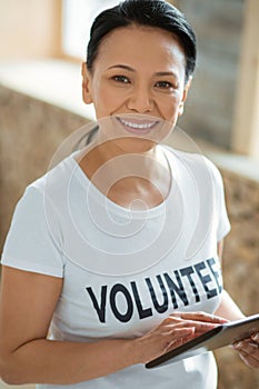 Beautiful female volunteer surfing Internet