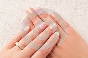 Beautiful females hands with manicure on white background. Trendy minimal spring summer nail design