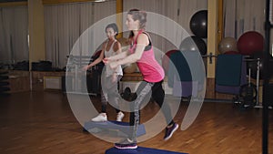 Beautiful females on the step board during exercise.