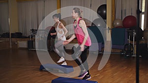 Beautiful females on the step board during exercise.