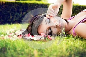 Beautiful feminine woman and flower petals