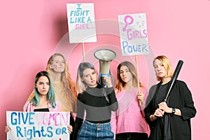 Beautiful feminists girls with megaphone and posters