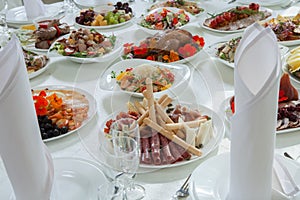 Beautiful festive table served for wedding celebration dinner at home or restaurant interior. Table full of food at a restaurant.